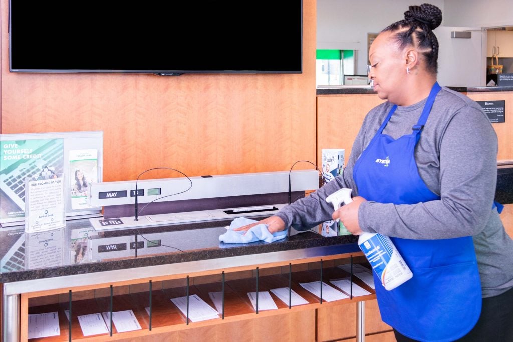system1 employee cleaning the shelf